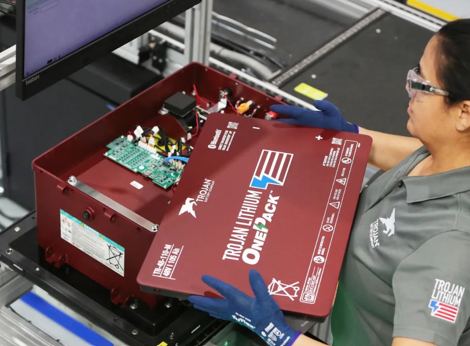 A factory worker inspects the electronics inside a lithium-ion battery pack designed to replace lead-acid batteries without expensive vehicle modifications (source: Trojan Battery Company).